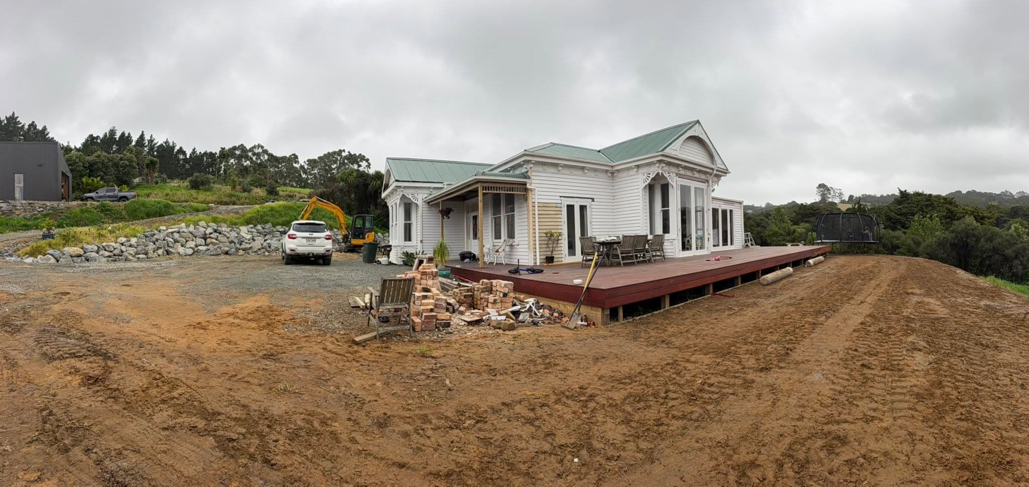 New build under construction with deck and diggers on site